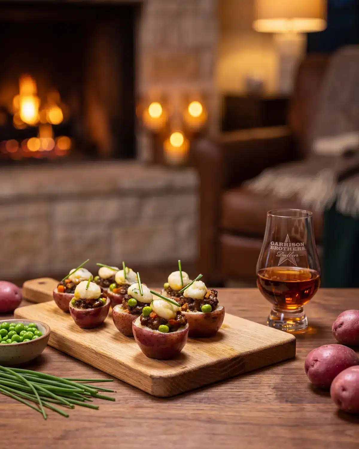 Bourbon Shepherd’s Pie Bites by a stone fireplace with a bottle of Garrison Brothers Small Batch Bourbon