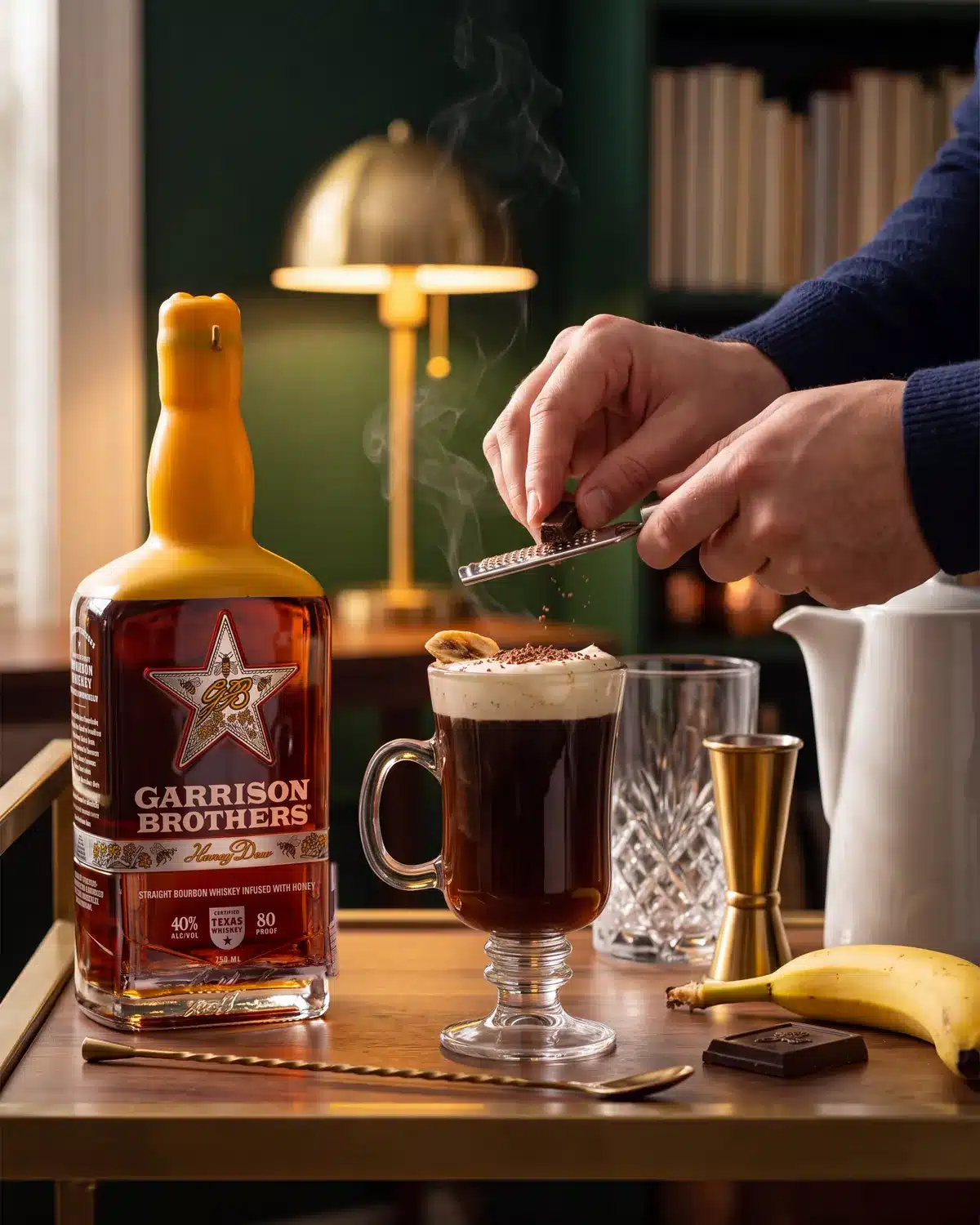 New Year, Same Me bourbon cocktail on a home bar cart with a bottle of Garrison Brothers HoneyDew Bourbon