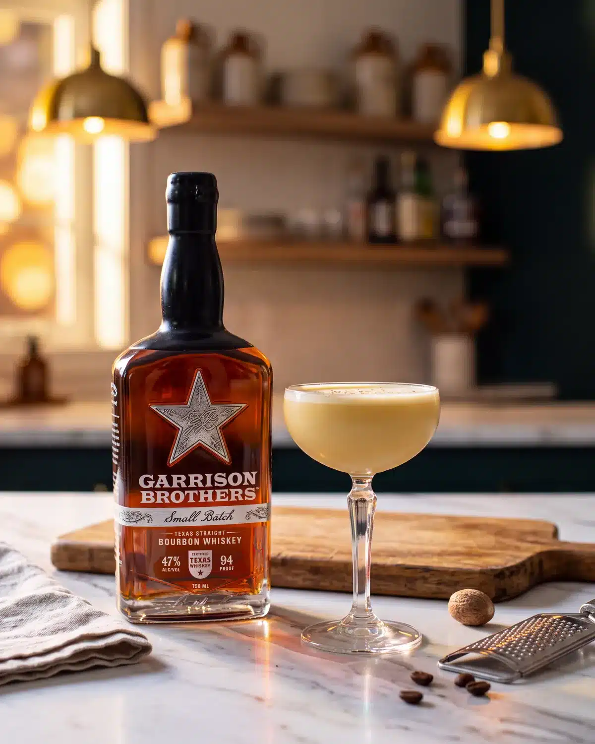 Yule Love It bourbon cocktail on a kitchen counter with a bottle of Garrison Brothers Small Batch Bourbon