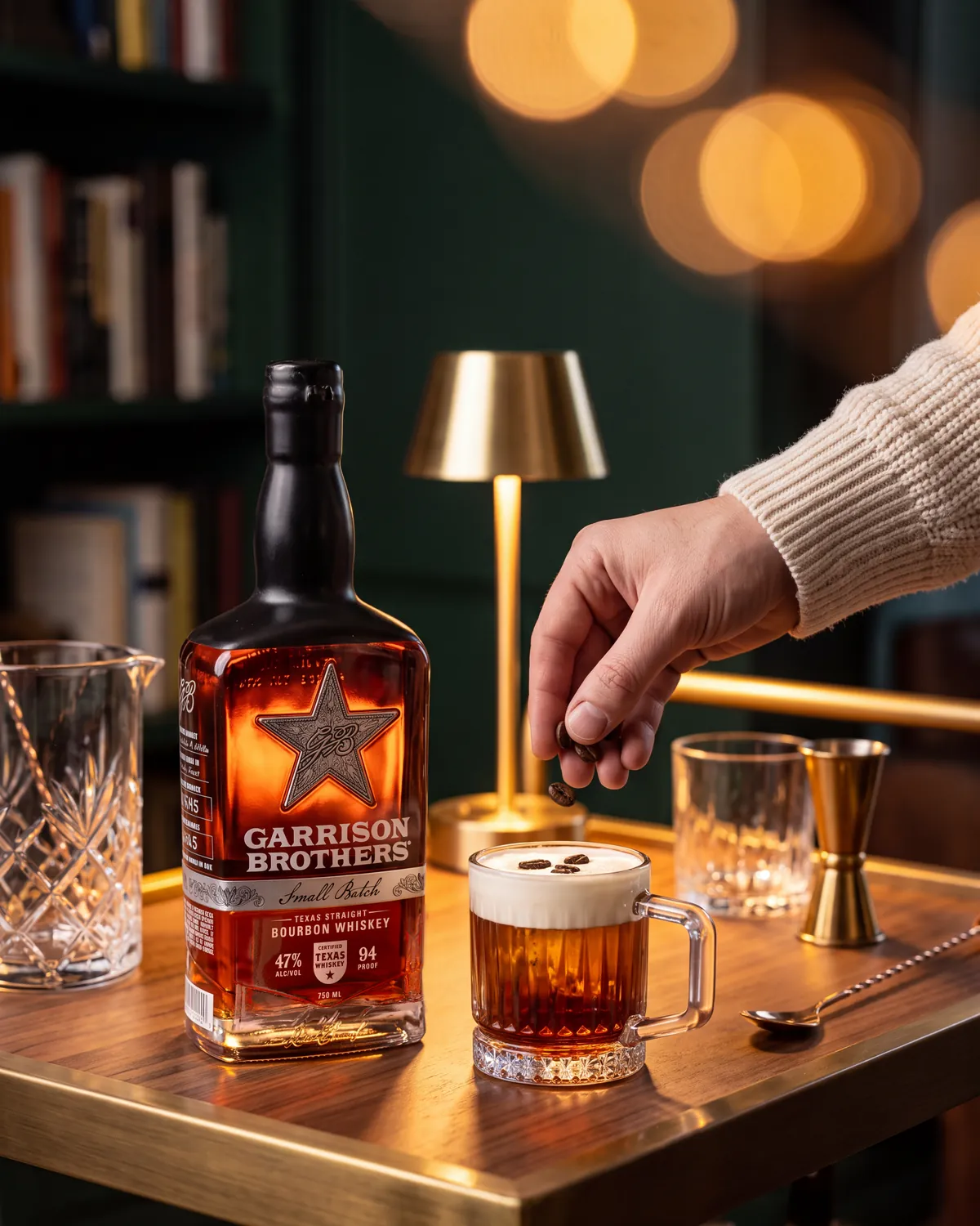 Arabica Old Fashioned bourbon cocktail on a home bar cart with a bottle of Garrison Brothers Small Batch Bourbon