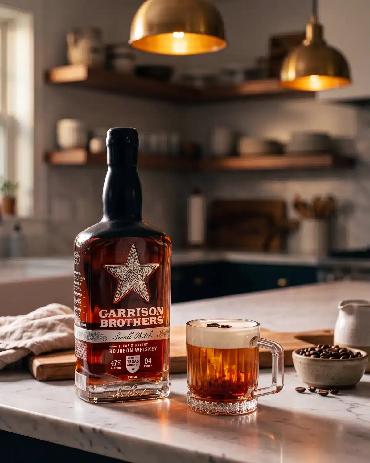Arabica Old Fashioned bourbon cocktail on a kitchen counter with a bottle of Garrison Brothers Small Batch Bourbon