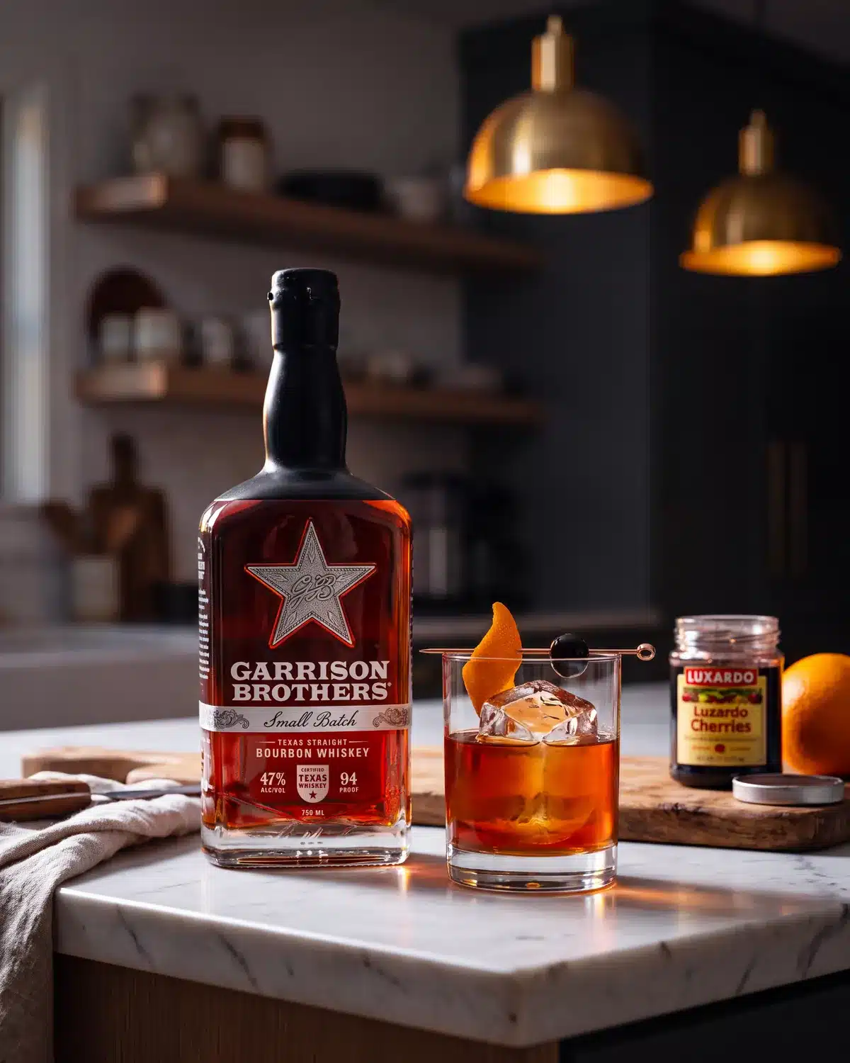 Tapped and Unwrapped bourbon cocktail on a kitchen counter with a bottle of Garrison Brothers Small Batch Bourbon