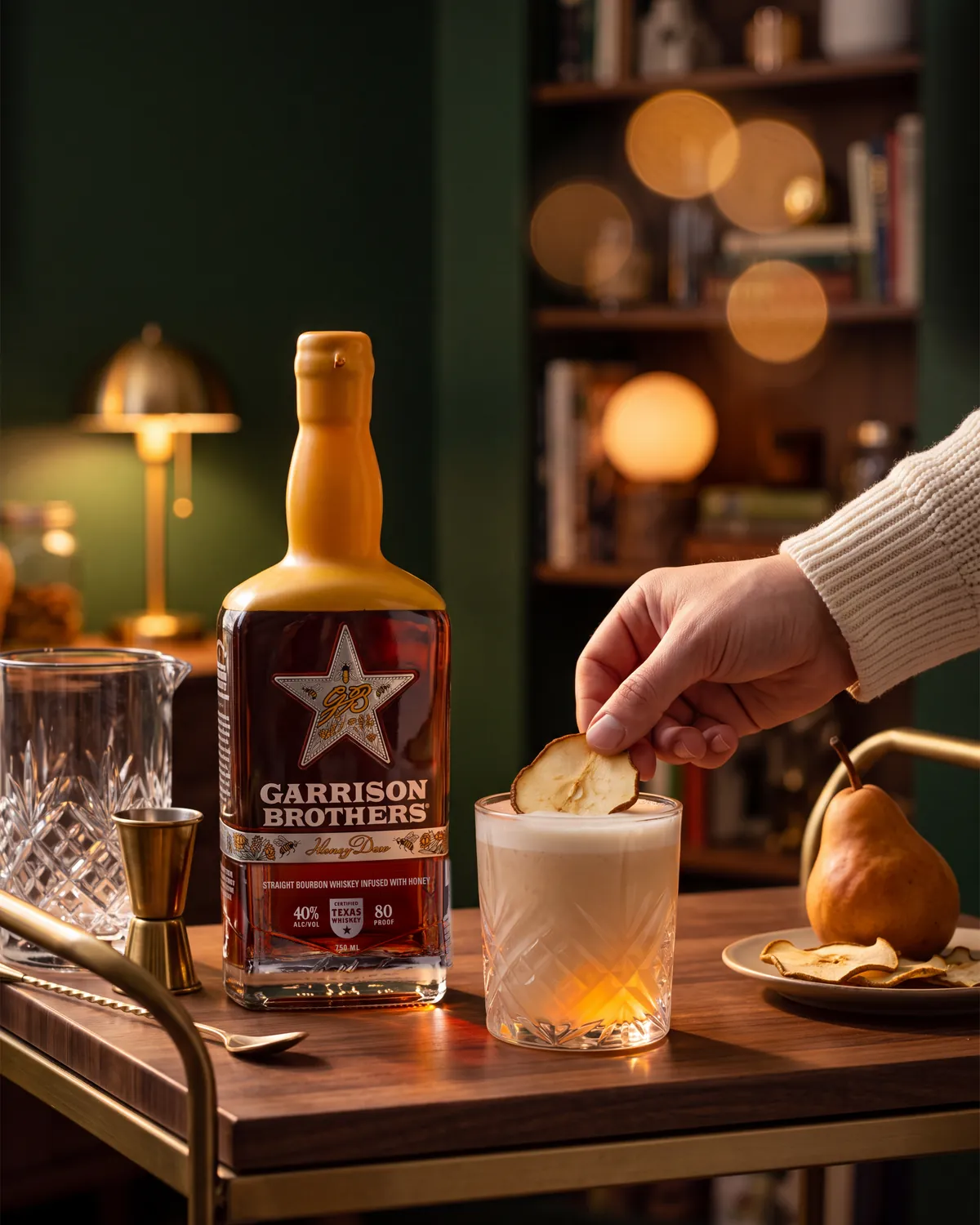 Pearis, Texas bourbon cocktail on a home bar cart with a bottle of Garrison Brothers HoneyDew Bourbon