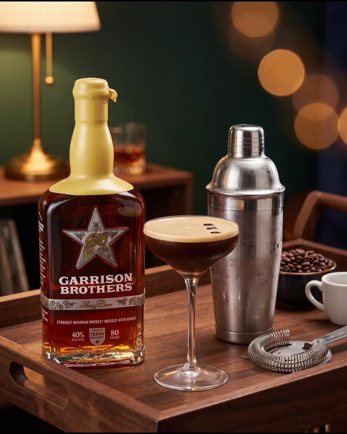 Midnight Drifter bourbon cocktail on a home bar cart with a bottle of Garrison Brothers HoneyDew Bourbon