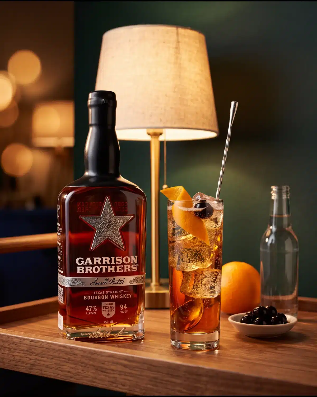 New Fashioned Highball bourbon cocktail on a home bar cart with a bottle of Garrison Brothers Small Batch Bourbon
