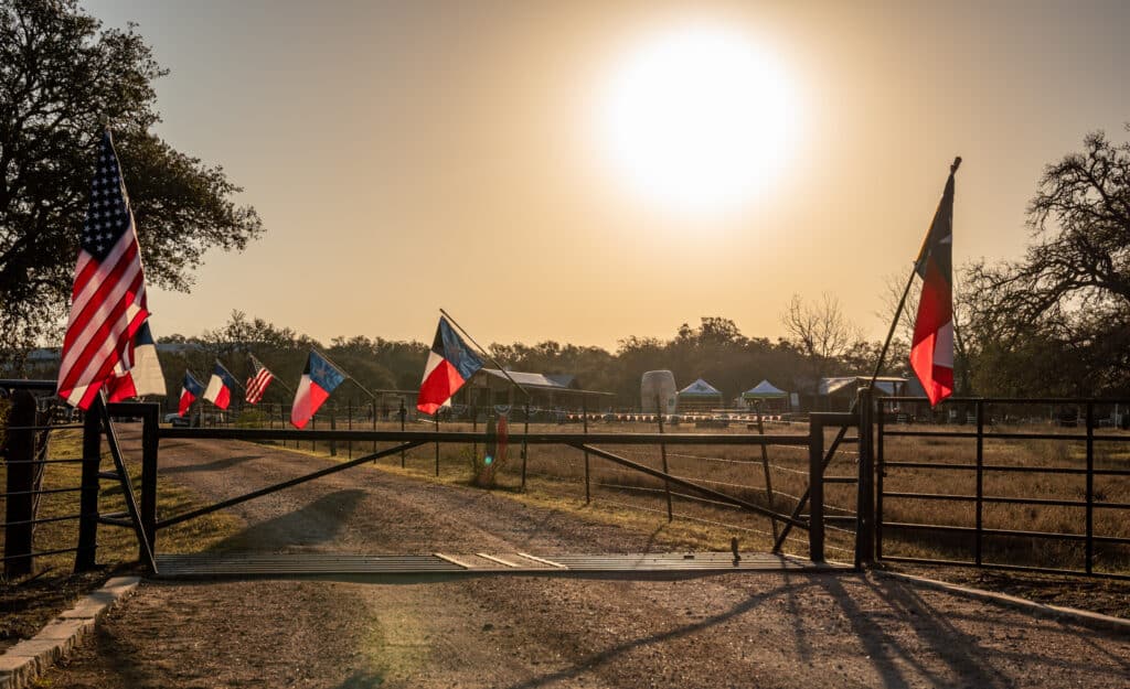 Entrance to Garrison Brothers Distillery with US and Texas flags