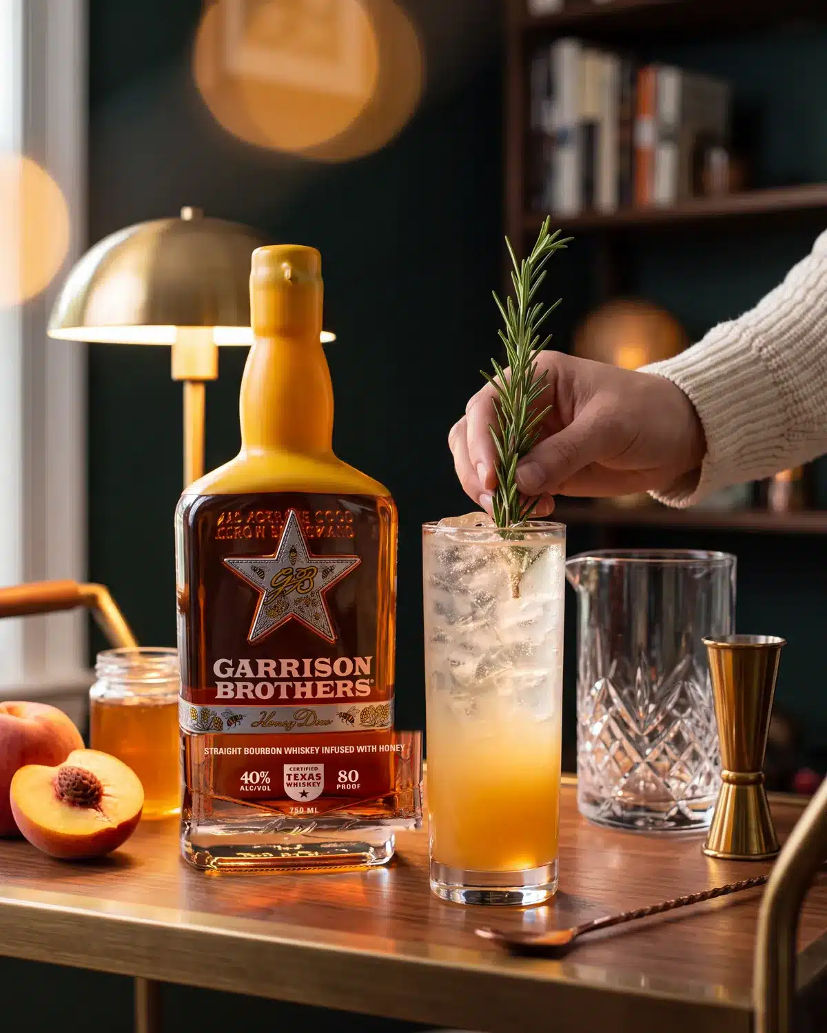 Smoking Gun bourbon cocktail on a home bar cart with a bottle of Garrison Brothers HoneyDew Bourbon